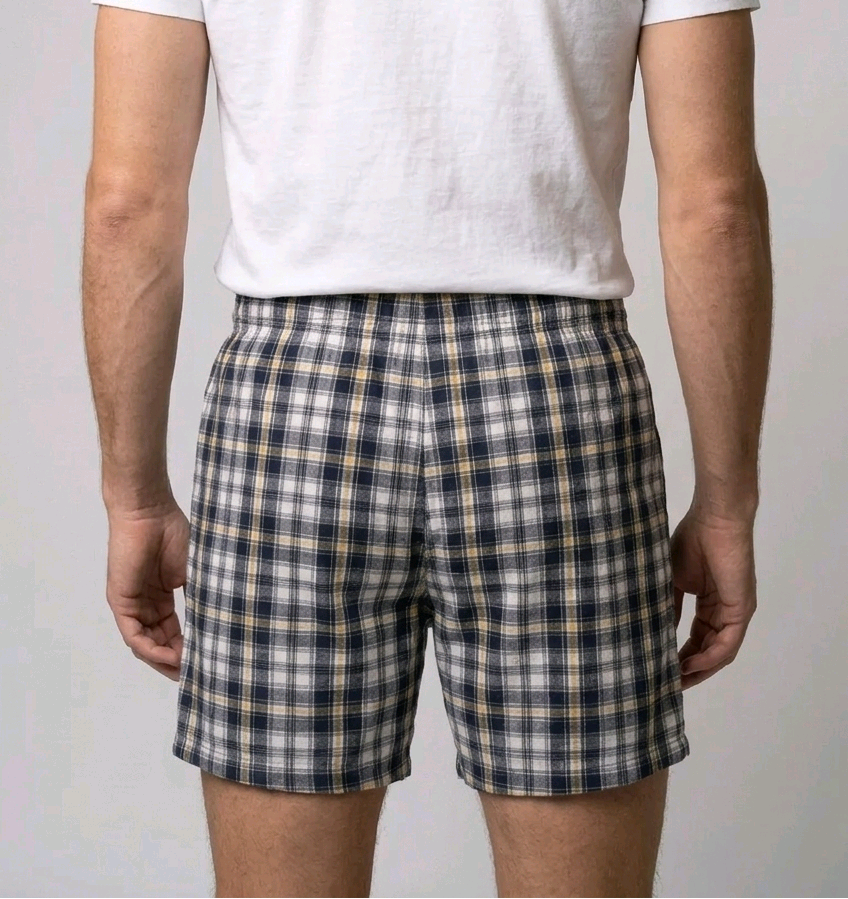 Man wearing plaid shorts and a white t shirt