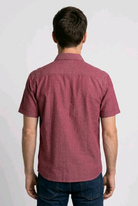 Man wearing a maroon short-sleeve shirt