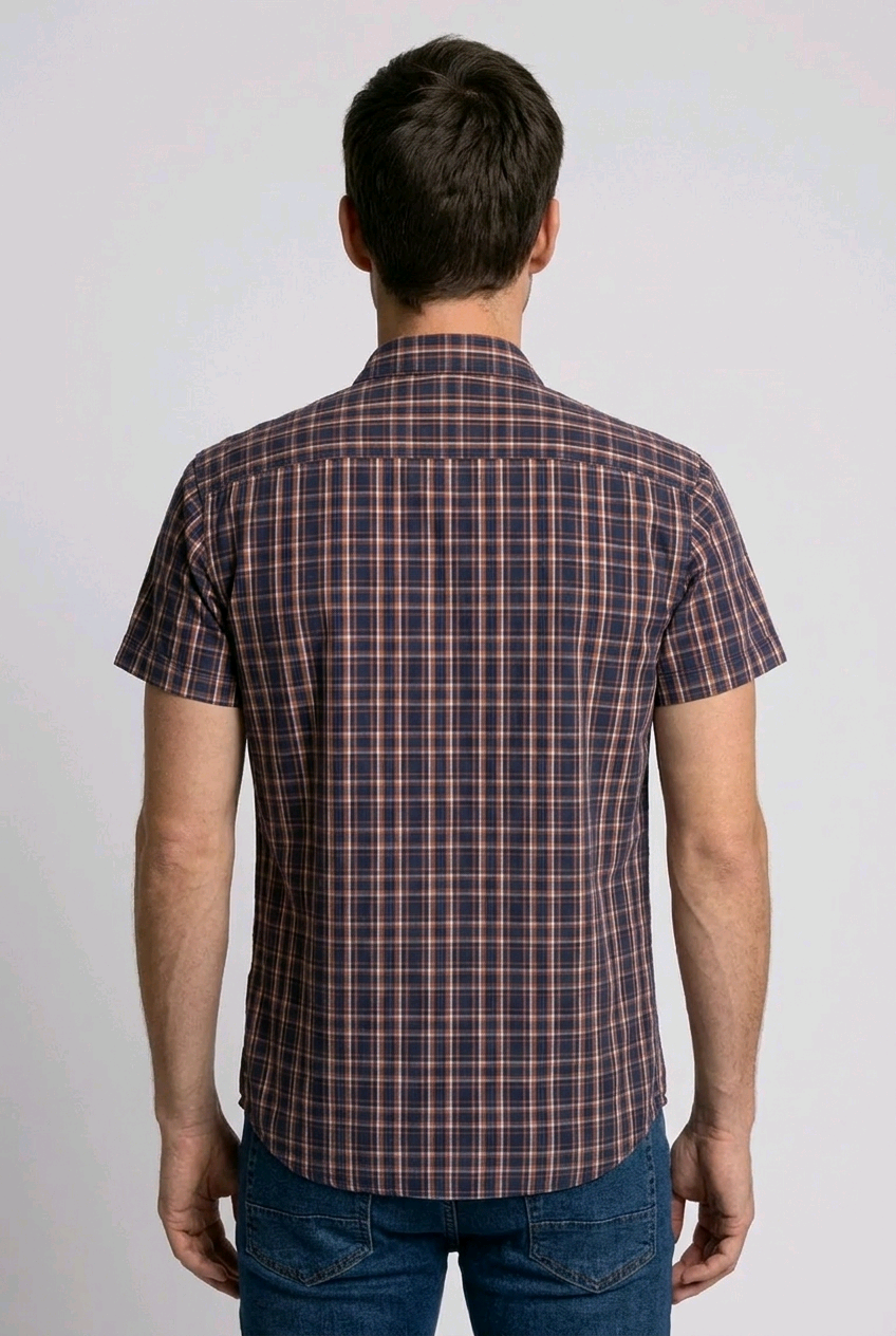 Man wearing a red, blue plaid shirt and jeans 