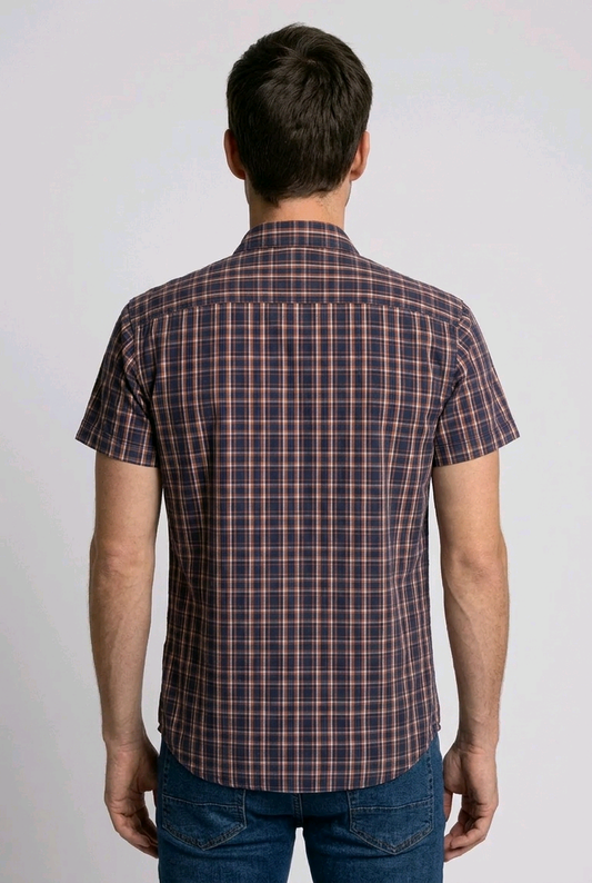 Man wearing a red, blue plaid shirt and jeans 
