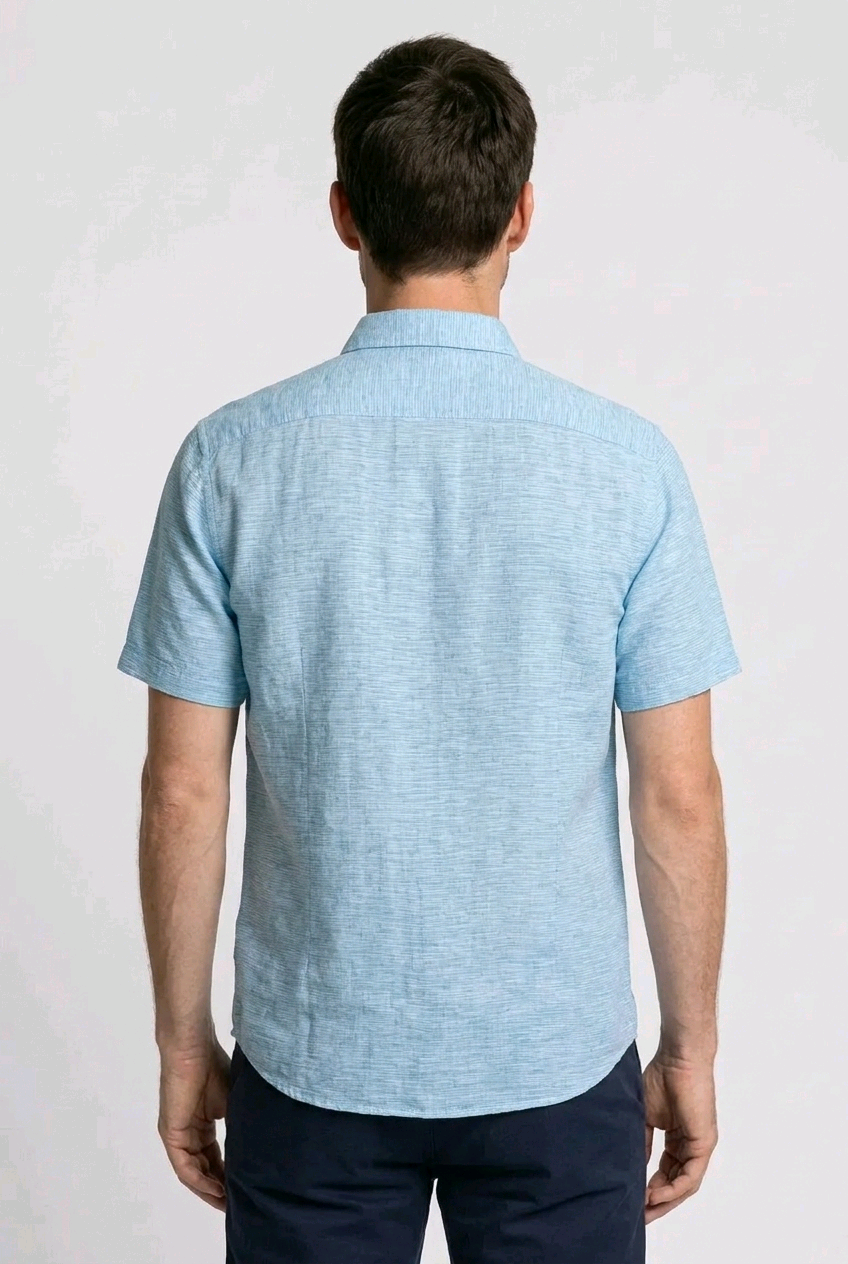 Man wearing a light blue short-sleeve shirt 