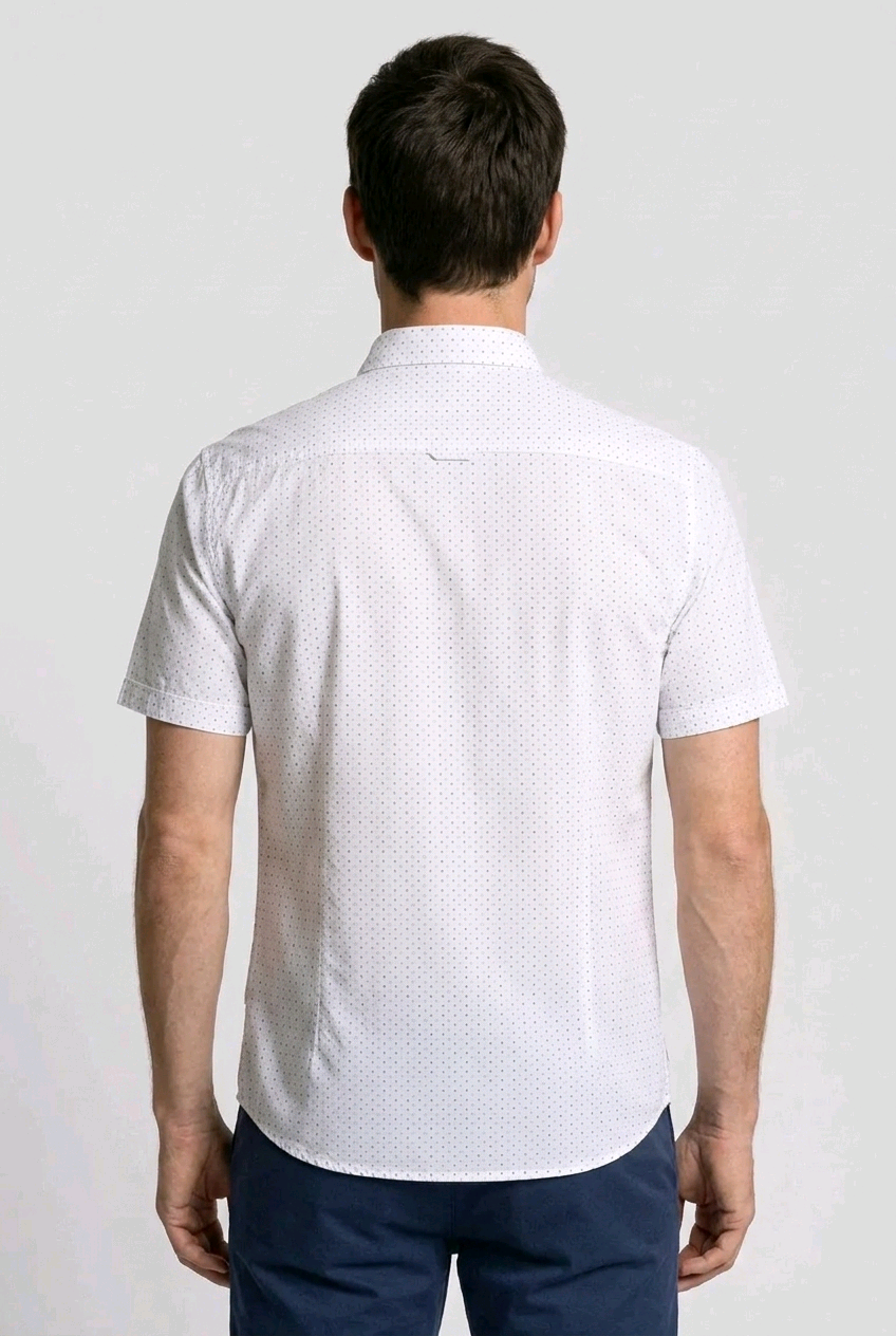 Man wearing a white short-sleeve shirt with a subtle pattern 