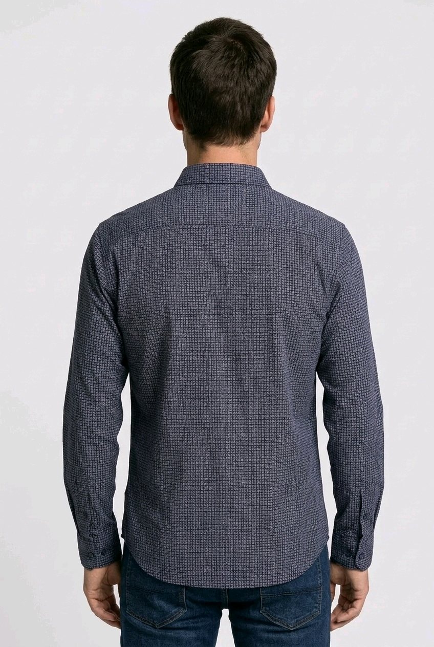 Man wearing a blue patterned shirt on a white background