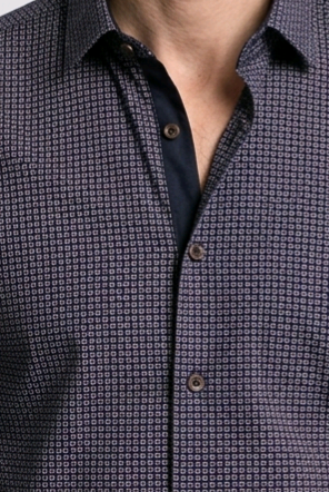 Close-up of a patterned shirt with a collar and buttons.