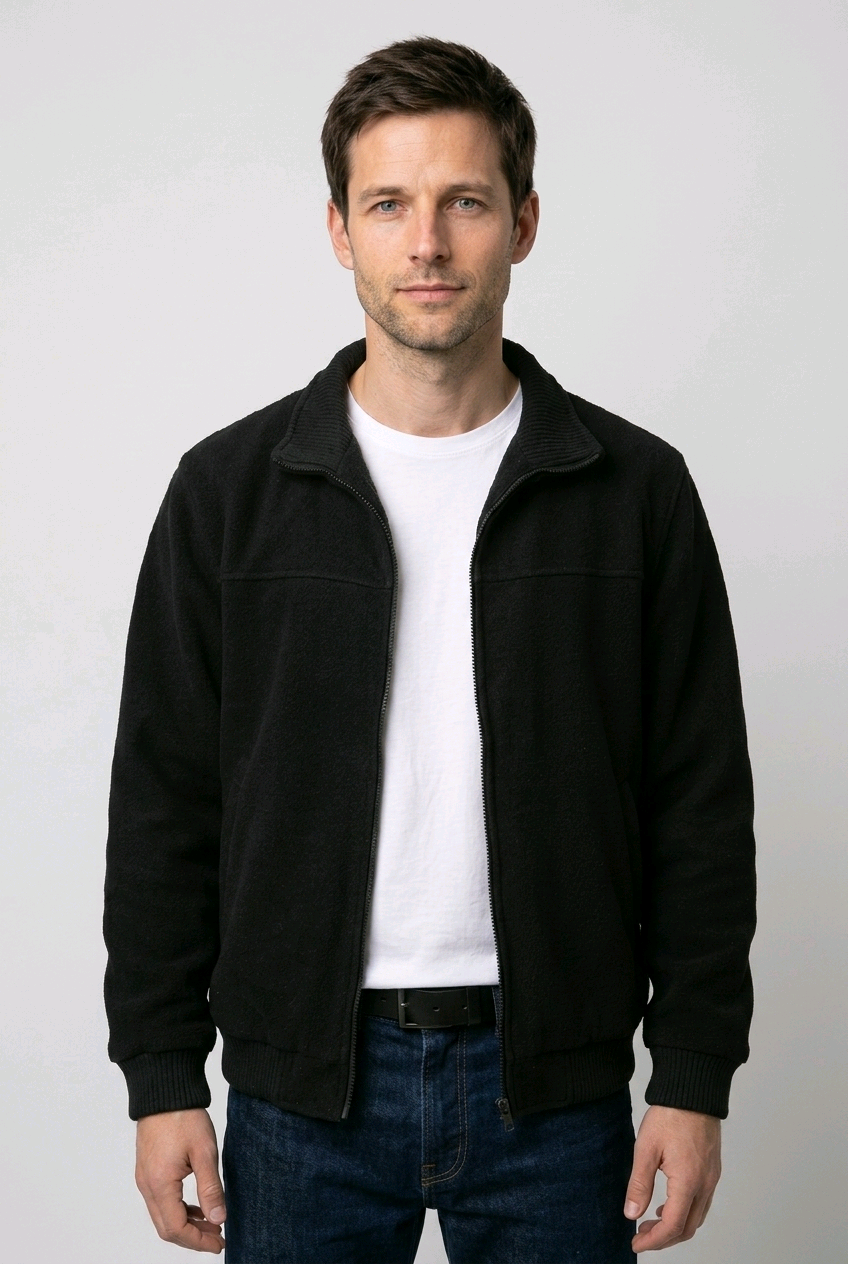 Man wearing a black jacket over a white shirt 