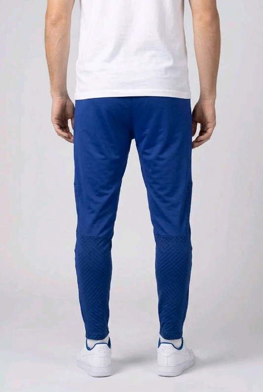 Person wearing blue joggers and white trainers