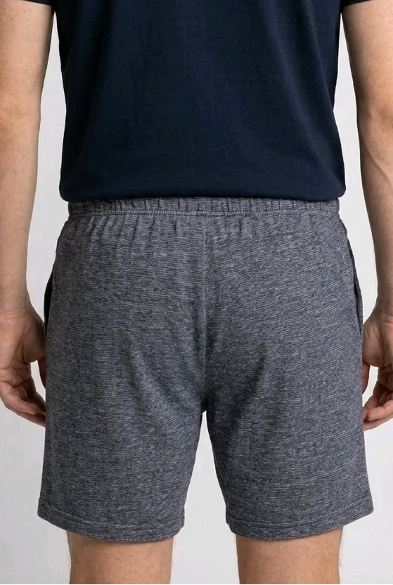 Man wearing a navy t-shirt and grey shorts