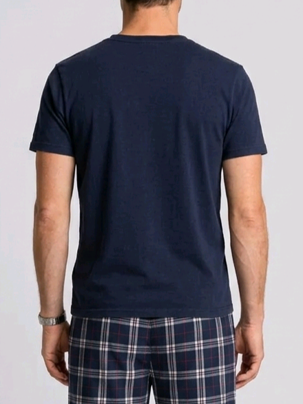Man wearing a navy blue t-shirt and plaid pants 