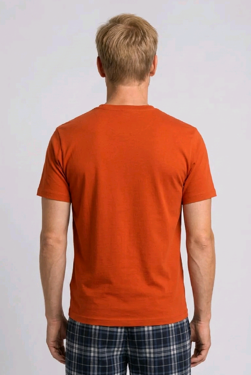 Man wearing an orange t-shirt and plaid pants