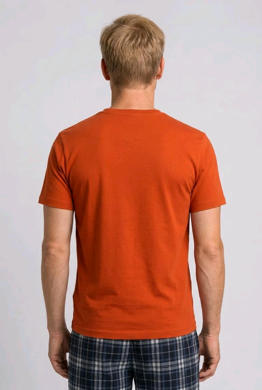 Man wearing an orange t-shirt and plaid pants