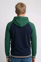 Man wearing a green and navy hoodie back view, preloved condition
