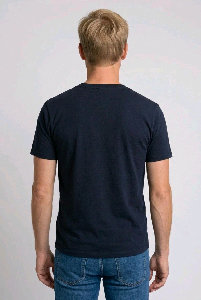 Man wearing a navy blue t-shirt and blue jeans