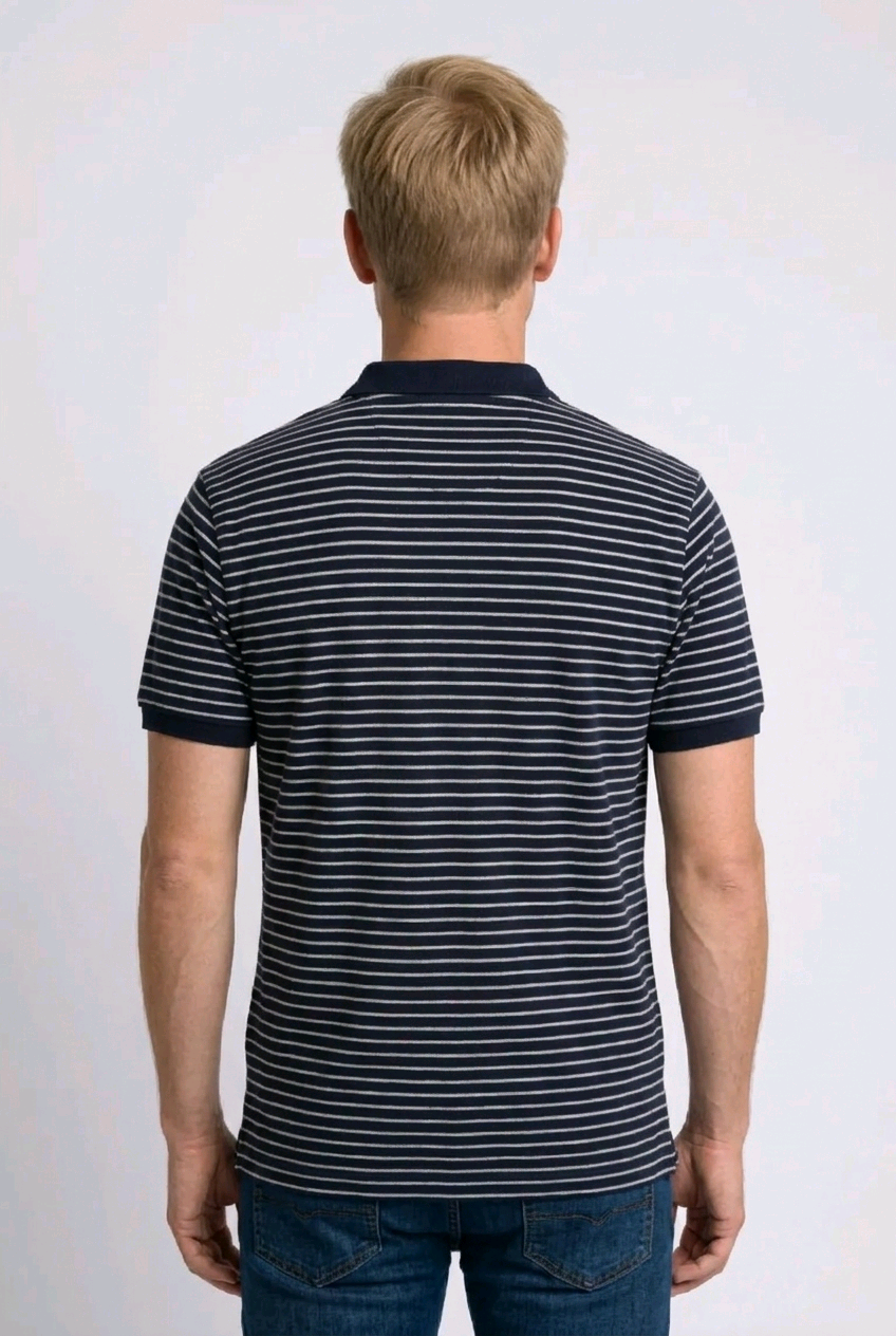 Man wearing a navy and white striped polo shirt 
