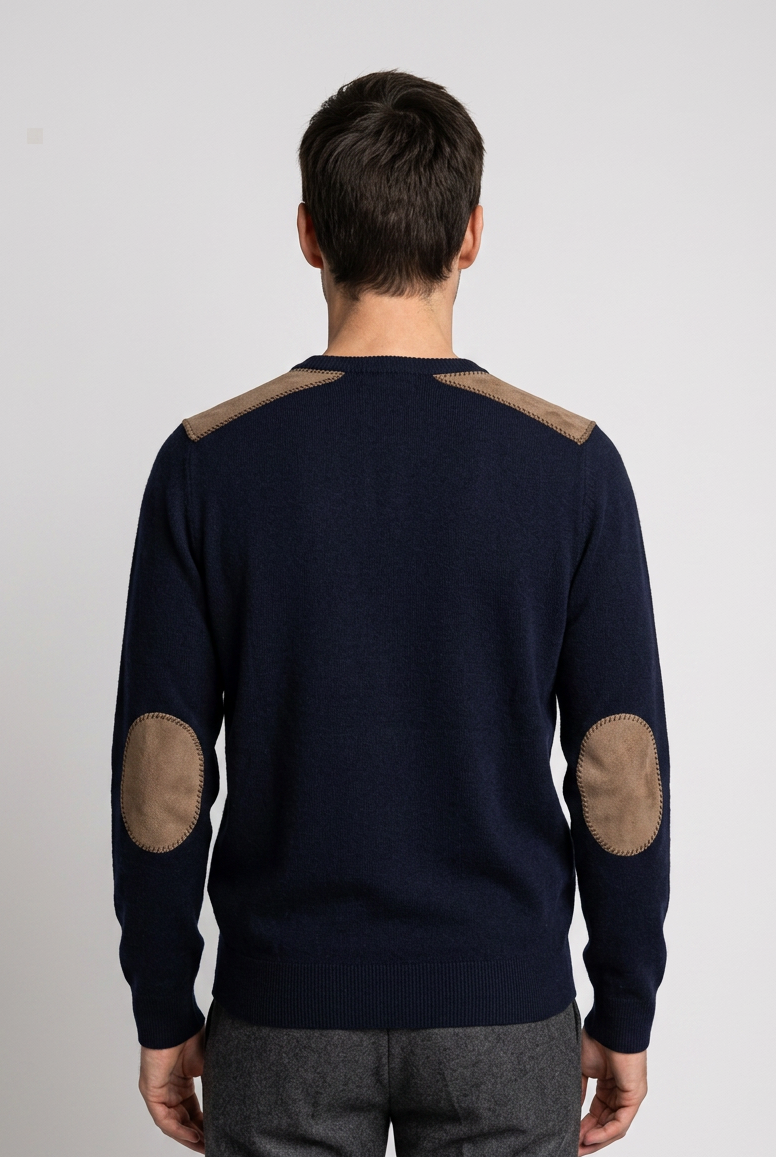 Man wearing a navy sweater with elbow patches 