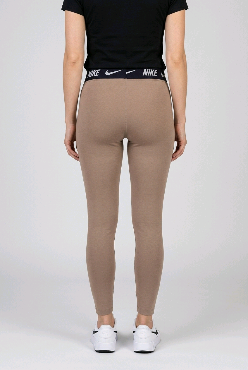 Person wearing beige Nike leggings with a black t shirt