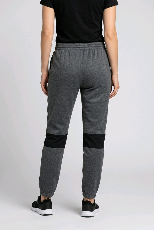 Woman wearing slate blue Adidas joggers back view
