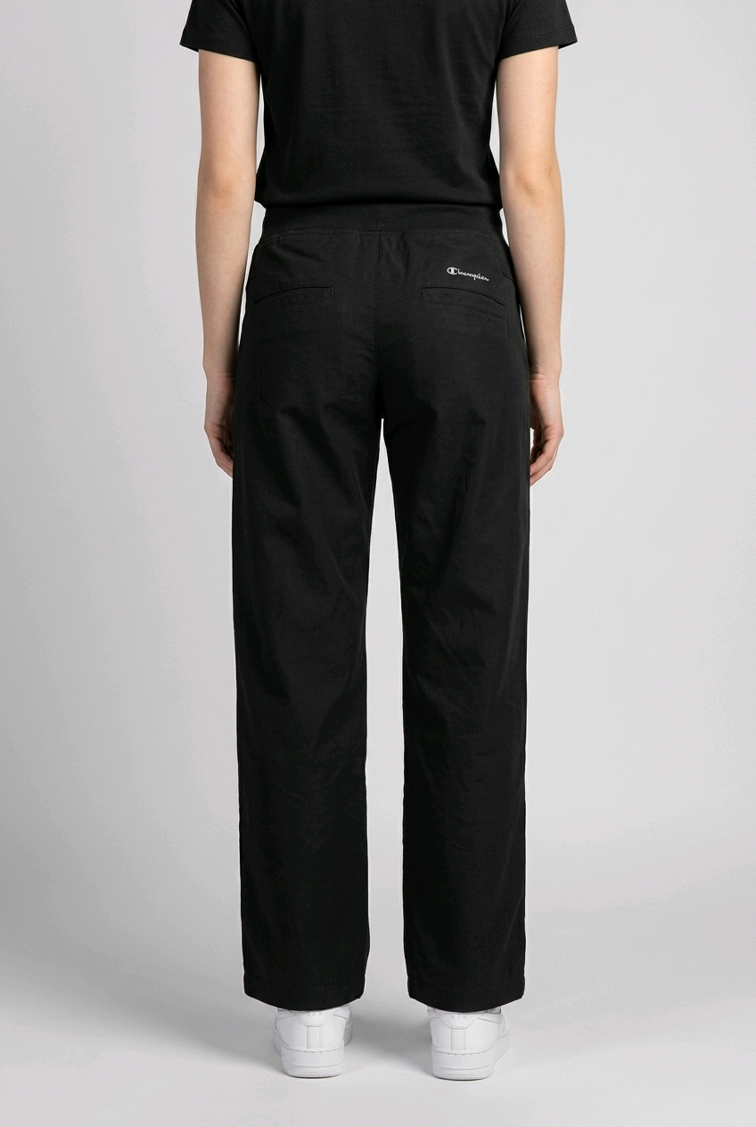 Woman wearing black champion joggers back view