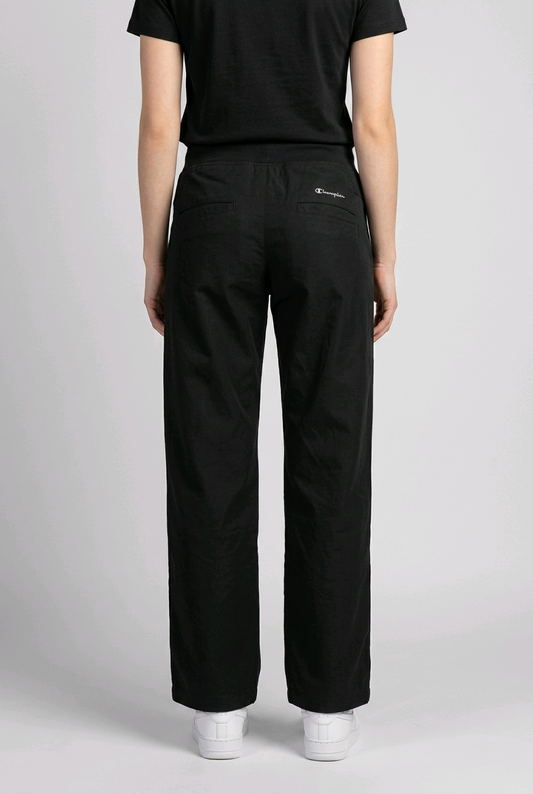 Woman wearing black champion joggers back view