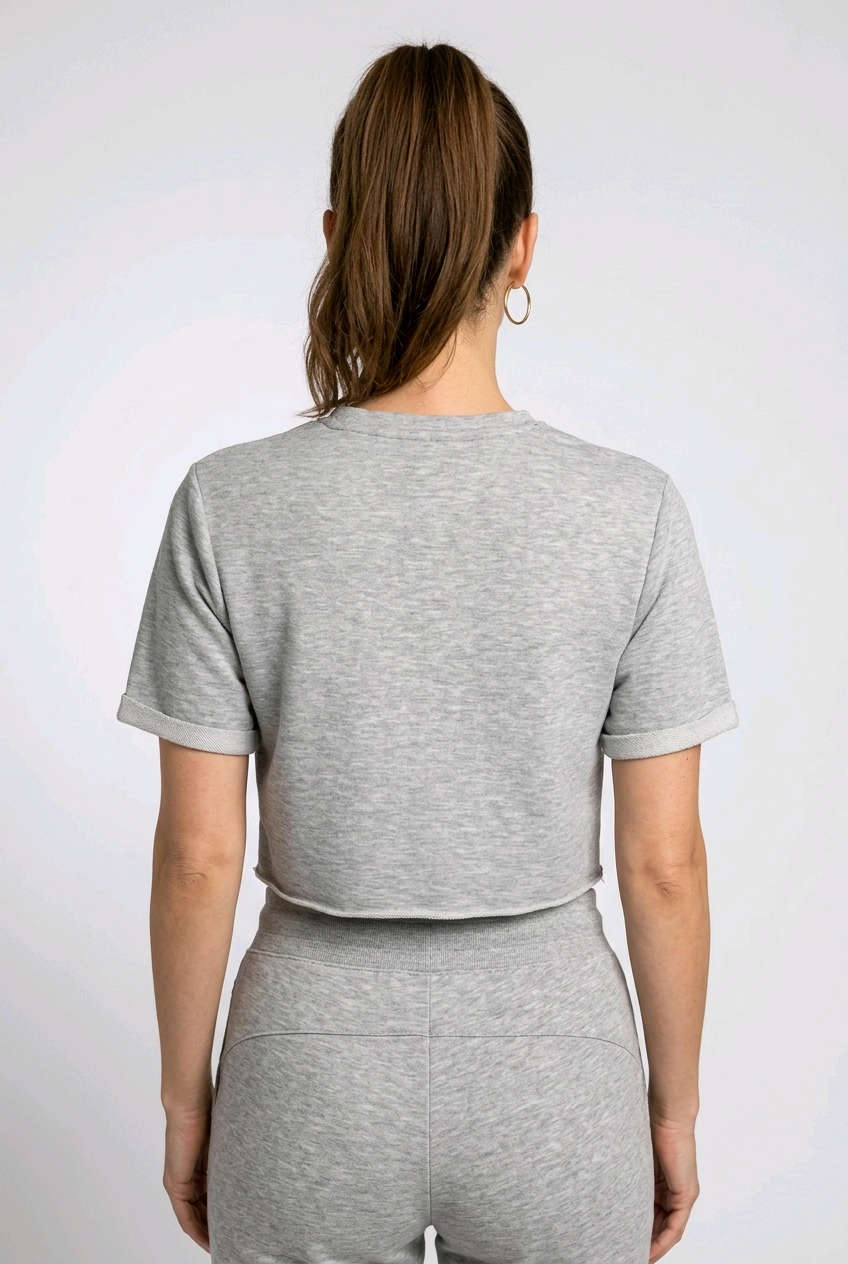 Woman wearing a grey gymking cropped top back view