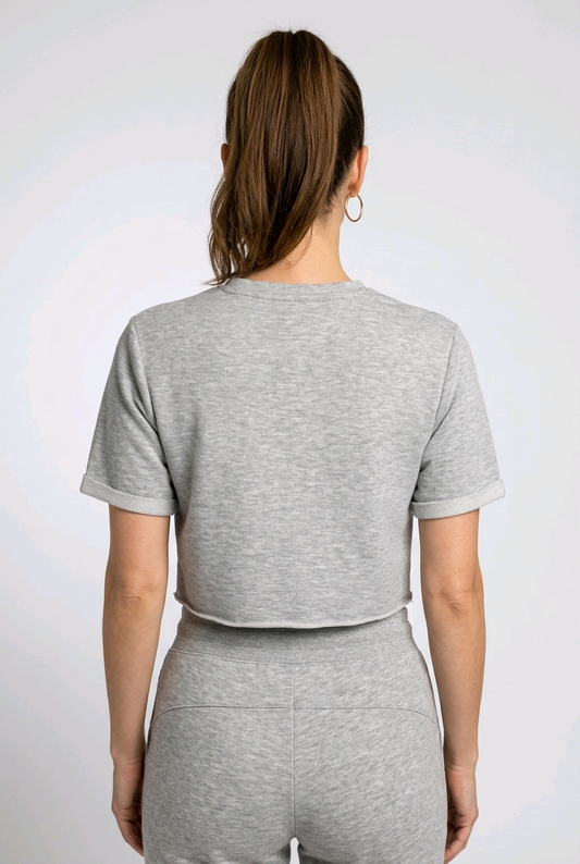 Woman wearing a grey gymking cropped top back view