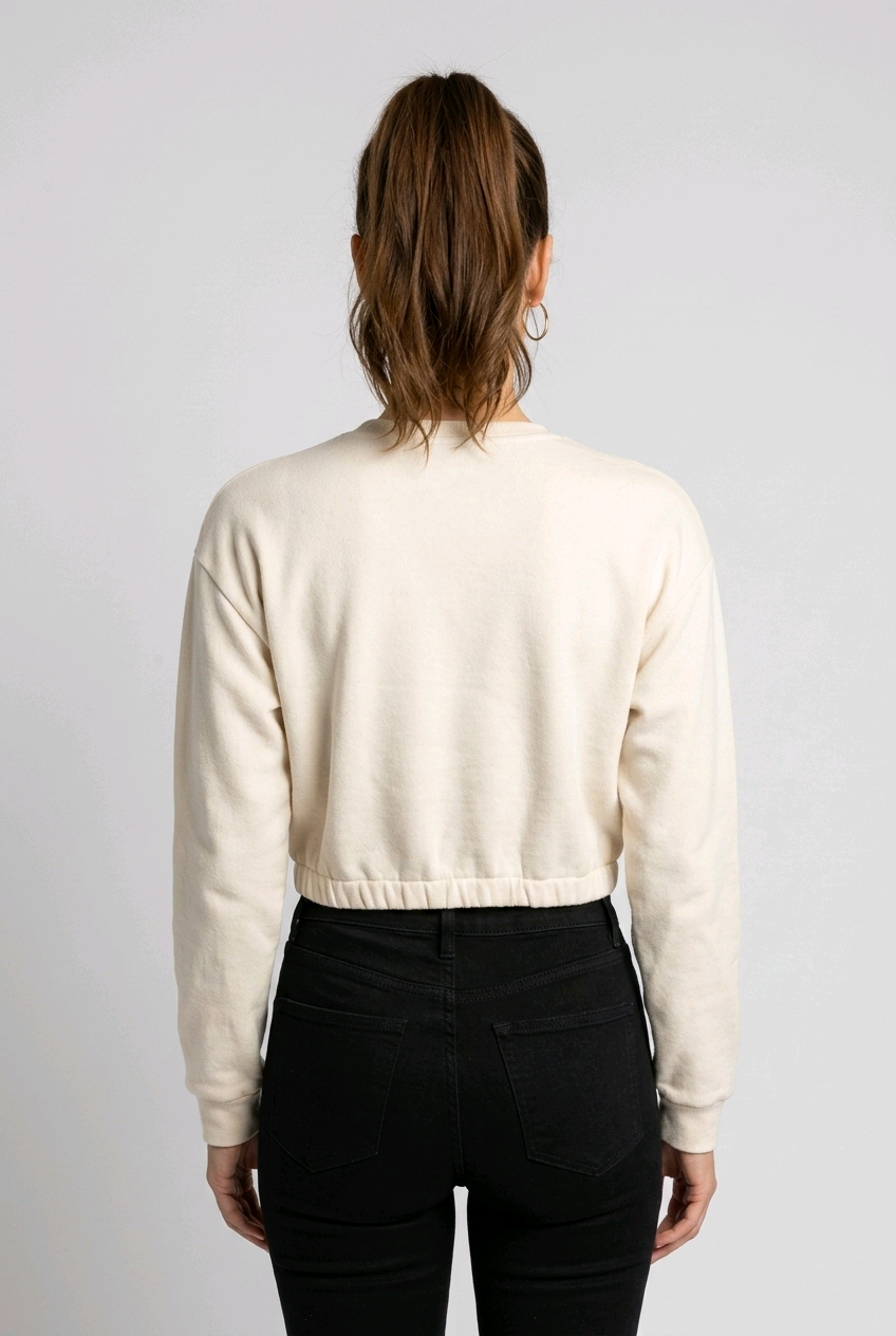 Woman wearing a cream cropped sweater