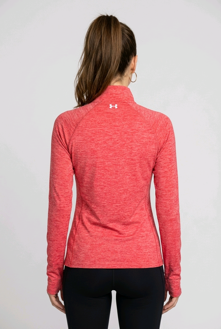 Woman wearing under armour red marl running top