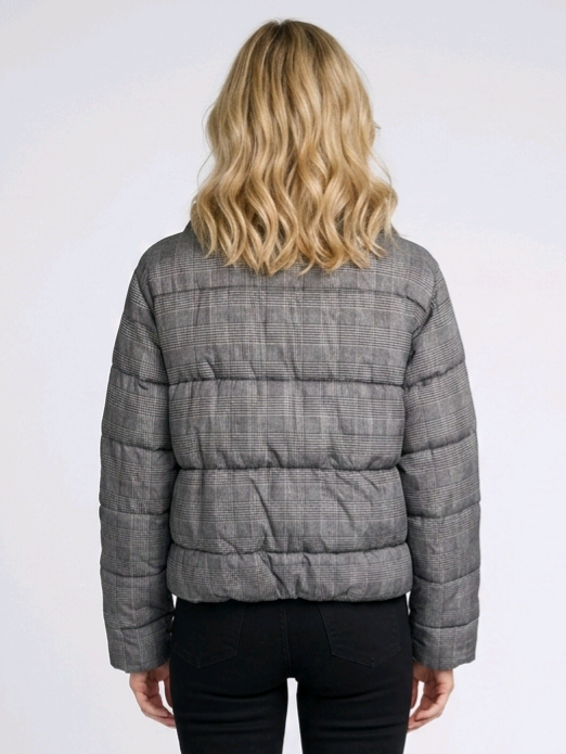 Woman wearing a grey check quilted jacket 