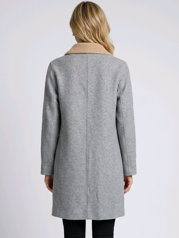 Woman wearing long grey coat