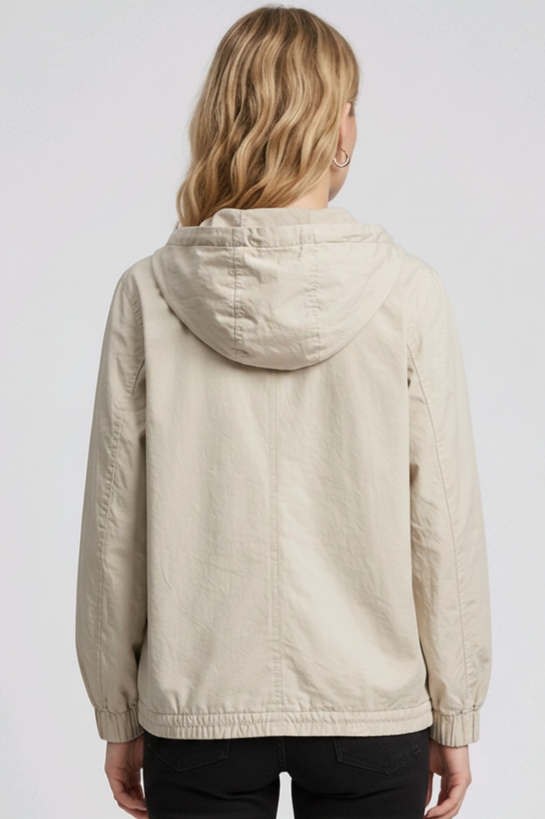 Woman wearing a beige hooded jacket 