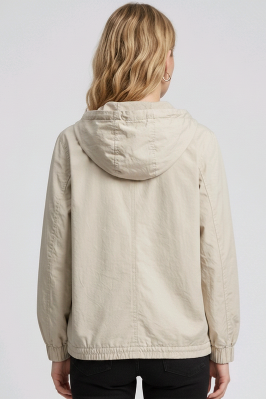 Woman wearing a beige hooded jacket 