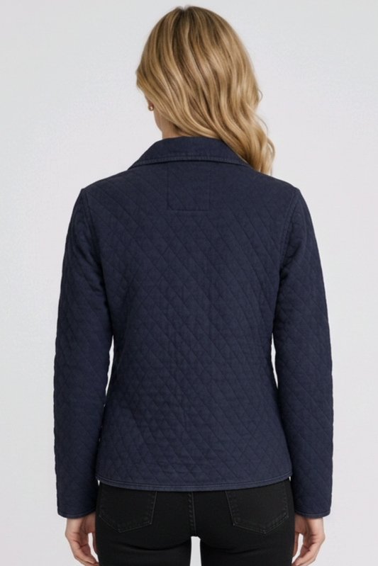 Woman wearing a navy quilted jacket 