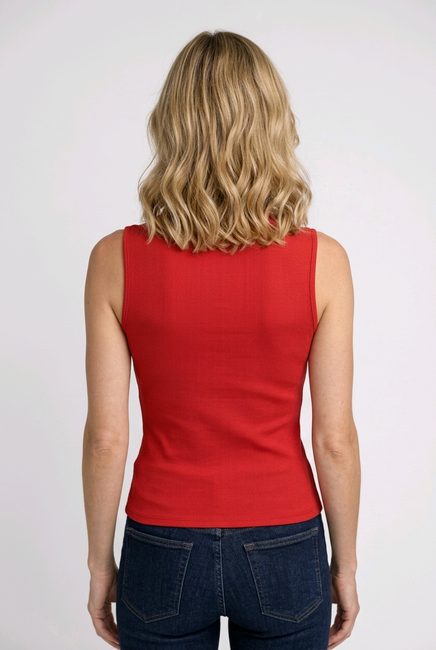 Person wearing a red sleeveless top and blue jeans 