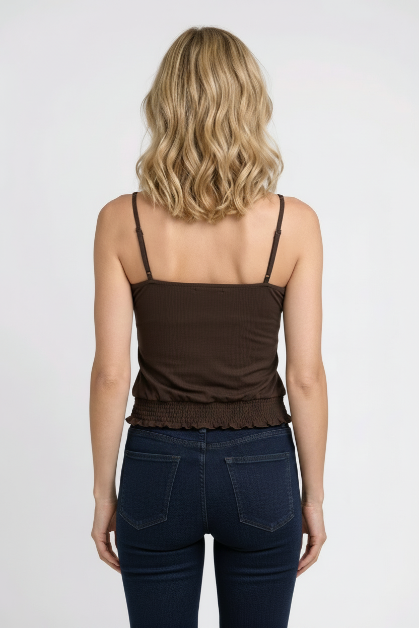 Woman wearing a dark brown cami top and navy jeans