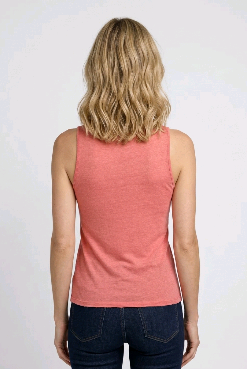 Person wearing a coral tank top and dark jeans