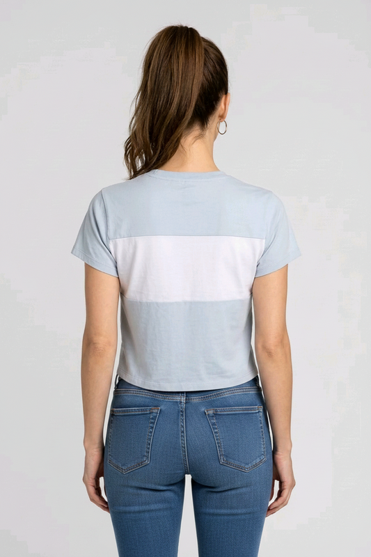 Woman wearing a light blue color-blocked t-shirt back view