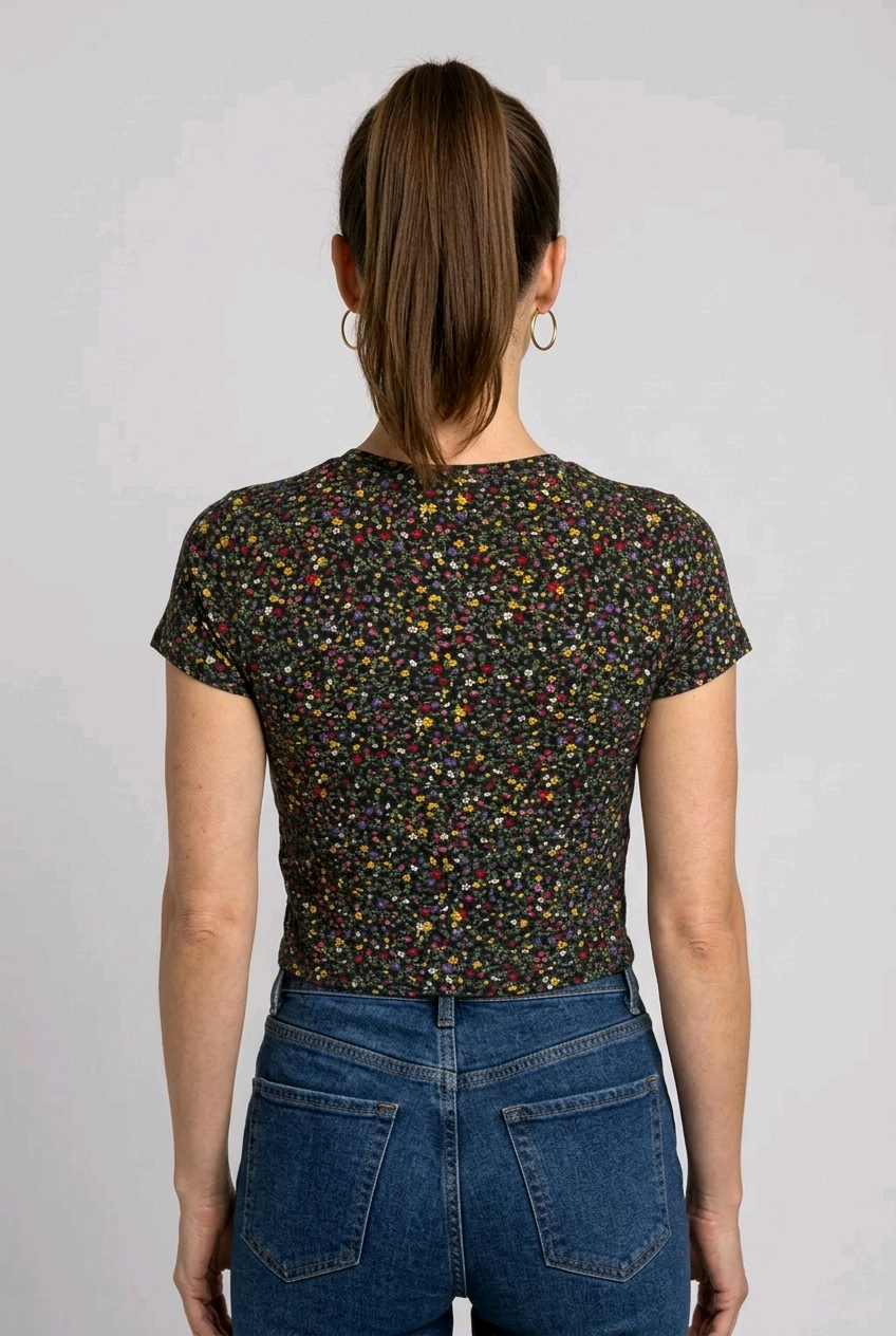 Woman wearing a black floral patterned T-shirt and blue jeans on