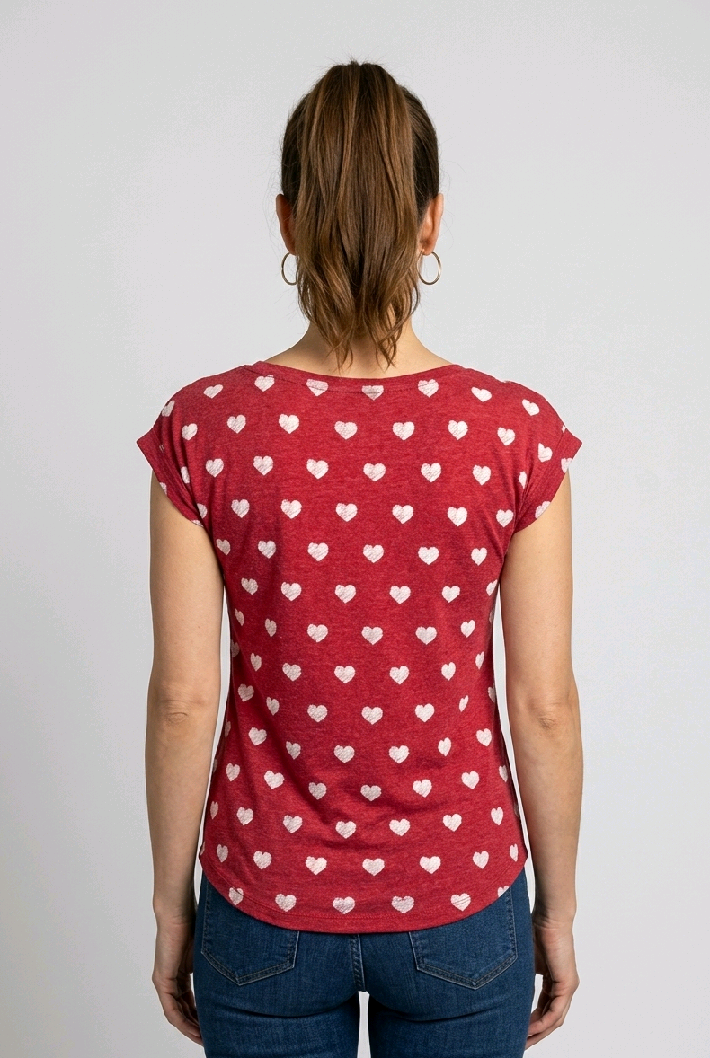 Woman wearing a red t-shirt with white heart patterns 