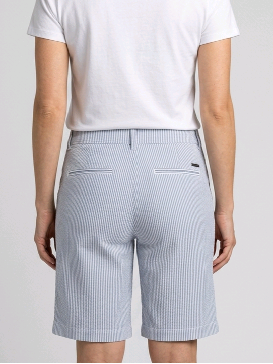 Woman wearing navy and white pinstripe shorts and a white t-shirt 
