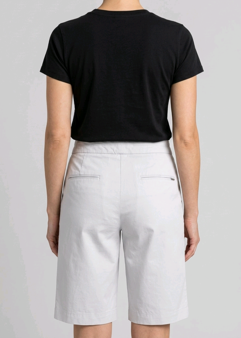 Woman wearing a black t-shirt and white shorts