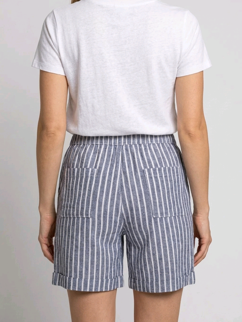 Person wearing a white t-shirt and blue striped shorts 