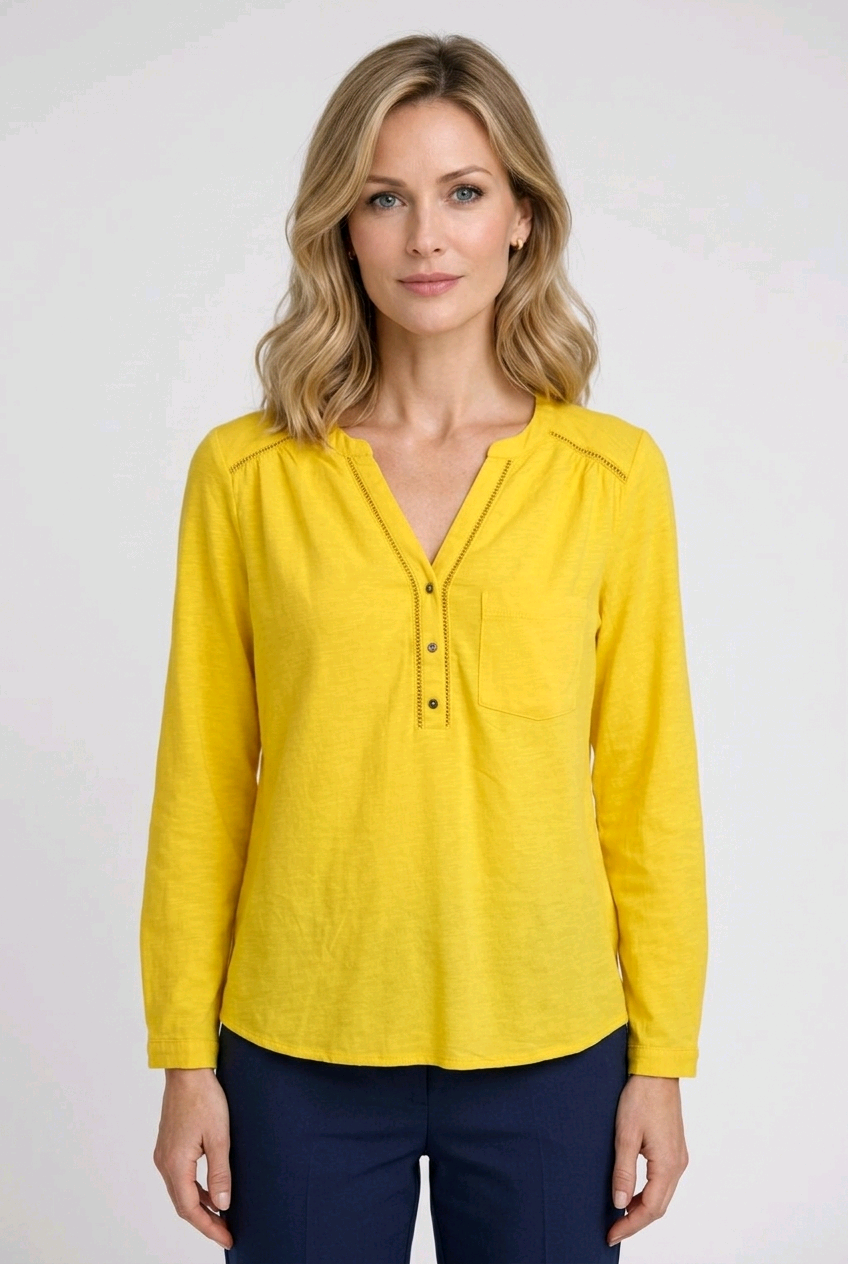 Woman wearing a yellow blouse with long sleeves 