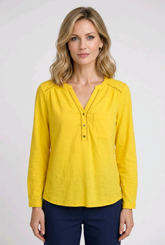 Woman wearing a yellow blouse with long sleeves 