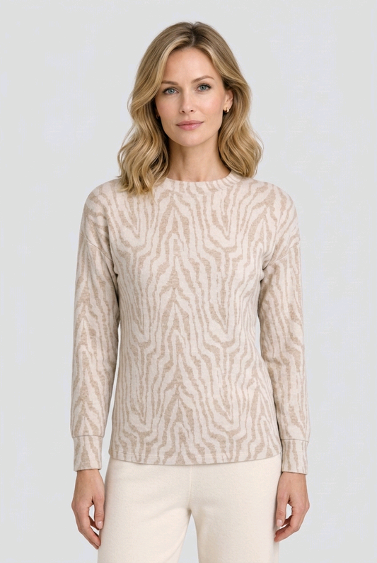 Woman wearing a beige patterned sweater 