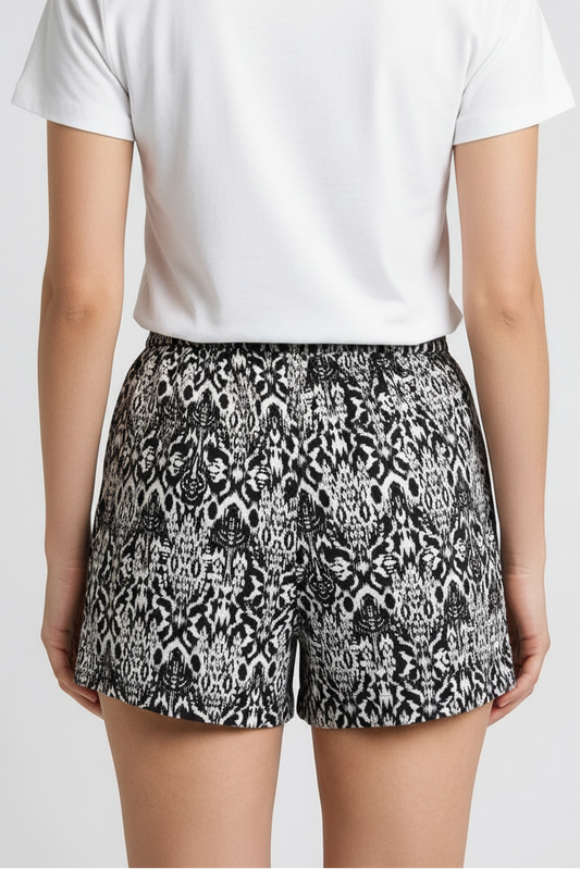 Woman wearing black & White pattern shorts back view