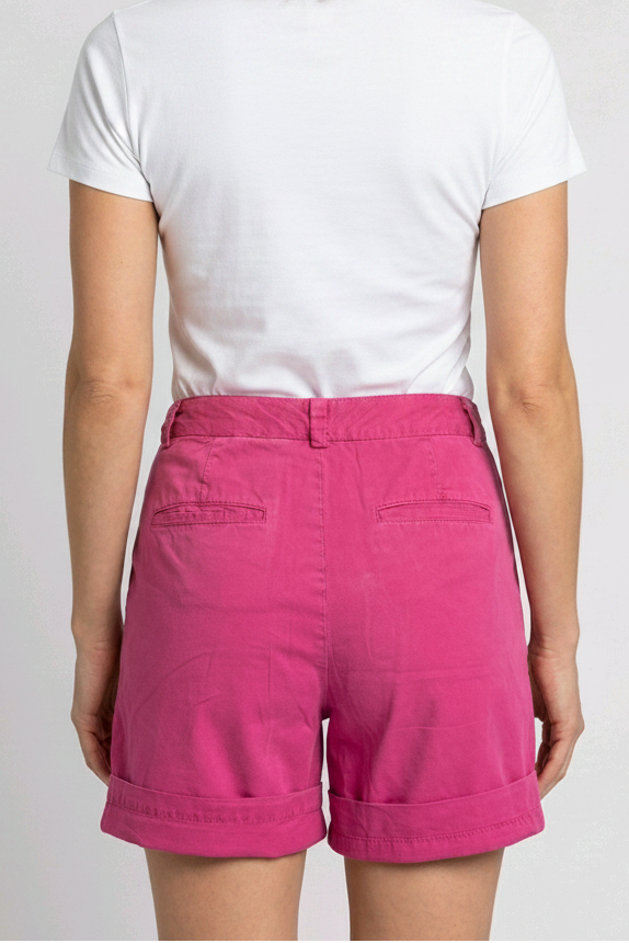 Woman wearing a white t-shirt and pink shorts 