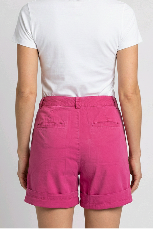 Woman wearing a white t-shirt and pink shorts 