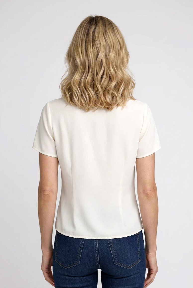 Woman wearing a white blouse and blue jeans back view