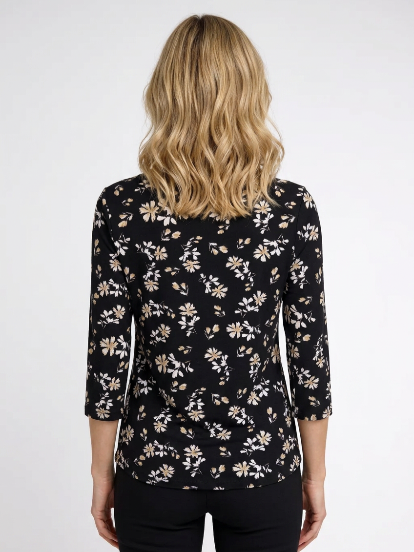 Woman wearing a black floral patterned top back view