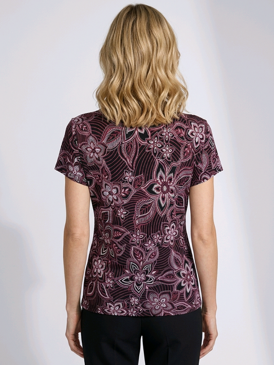 Woman wearing a patterned blouse  back view