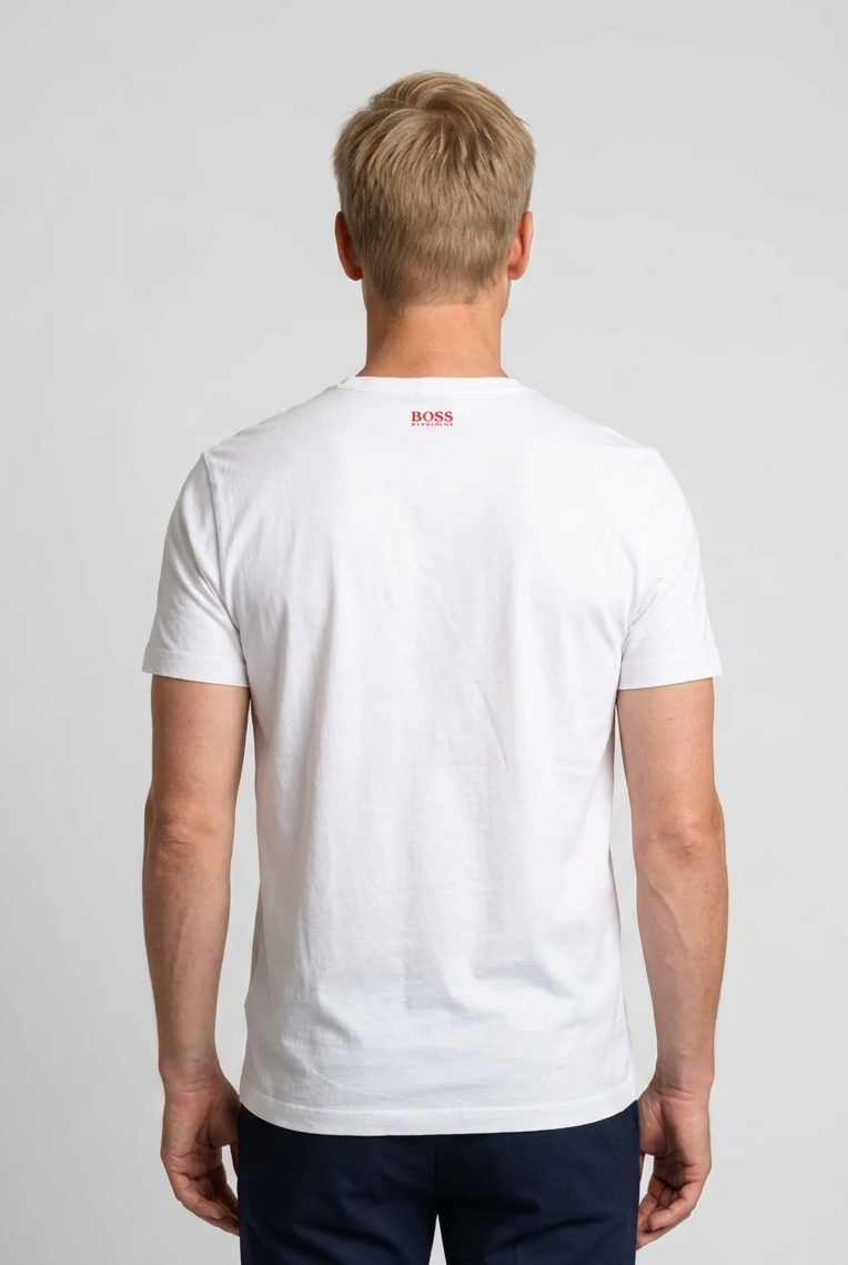 Man wearing a white t-shirt with a Hugo Boss logo on the back 